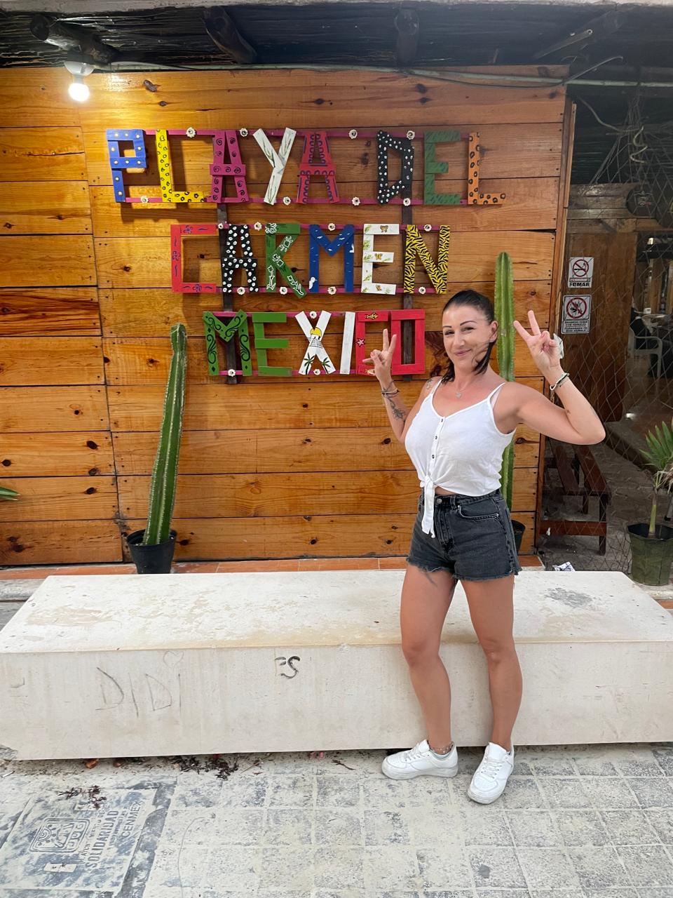 Melanie at the Playa del Carmen sign